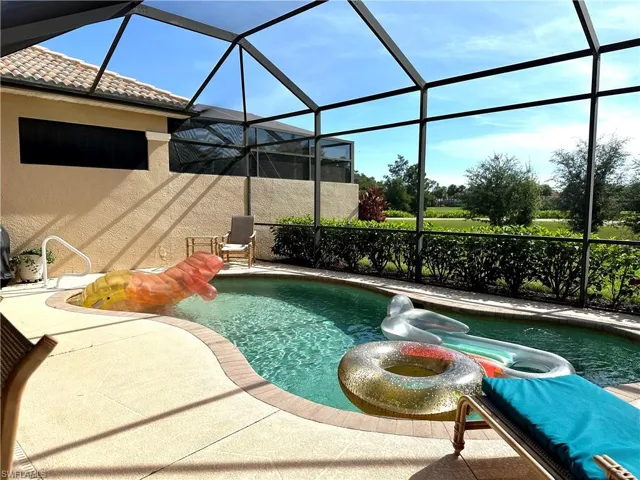 View of pool with a patio and a lanai