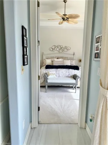 Carpeted bedroom with ceiling fan