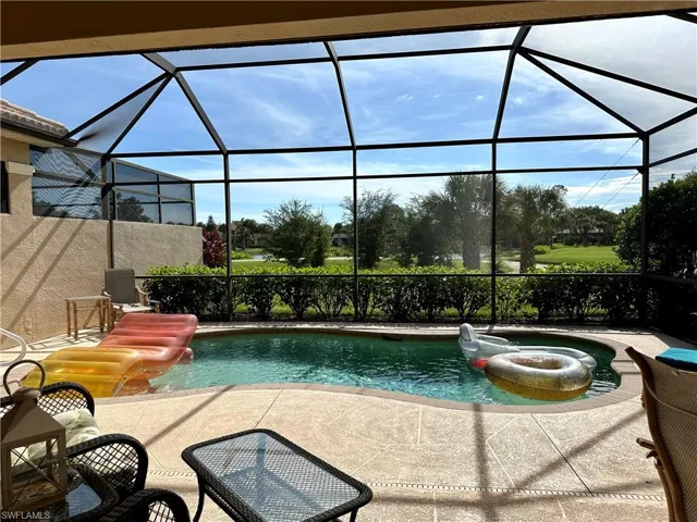 View of pool featuring a patio area, a lanai, and a jacuzzi