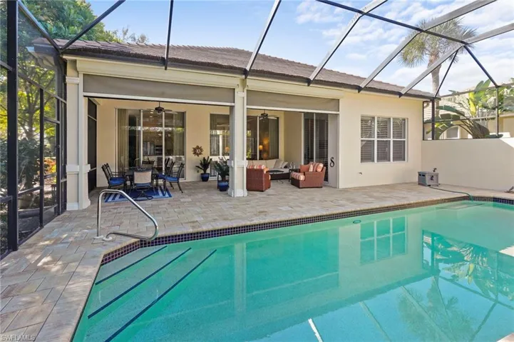 Rear view of property with a sunroom, a lanai, and a patio area