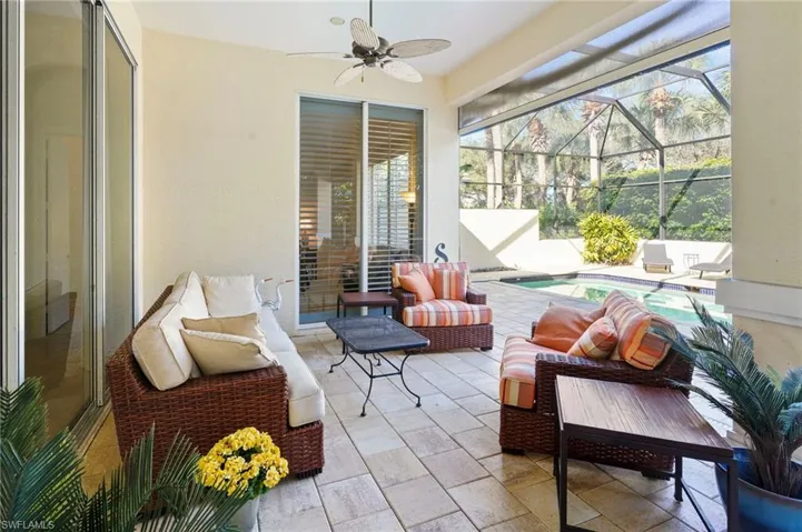 Sunroom with a patio, a ceiling fan, and outdoor furniture