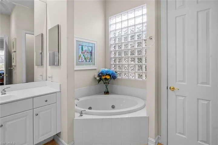 Bathroom with a jetted tub and vanity