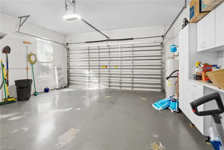 Garage with water heater and a garage door opener