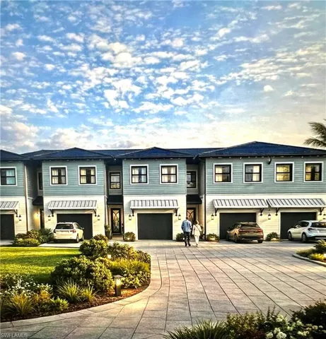 Modern townhome exteriors featuring light blue siding with dark blue roofing
