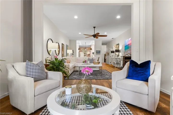 Living room featuring ceiling fan and hardwood / wood-style floors