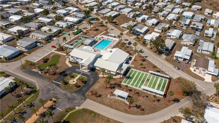 Aerial overview of property's location featuring nearby suburban area and a pool
