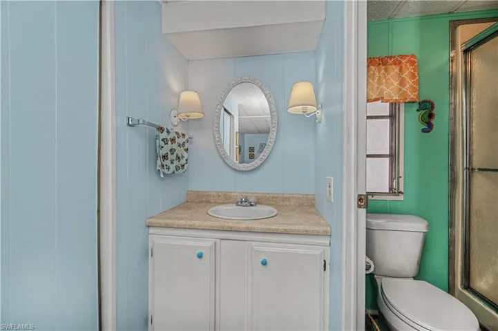 Full bath featuring vanity and an enclosed shower
