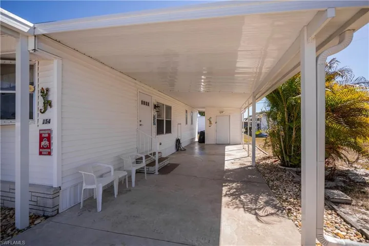 Covered porch featuring entry steps