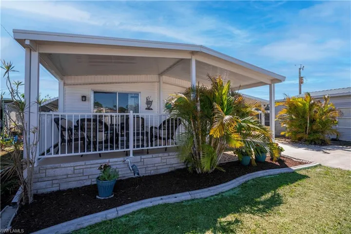 Back of property featuring a yard