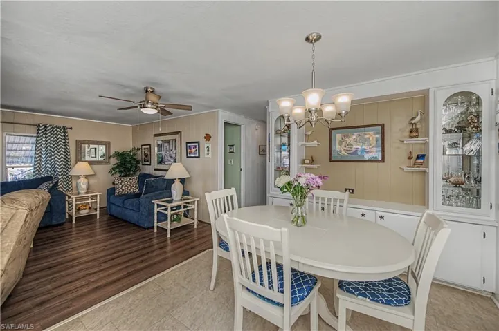 Dining space with ceiling fan and a chandelier