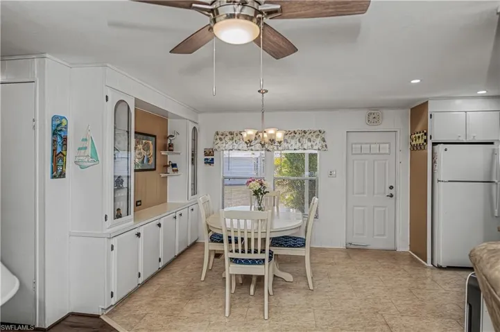 Dining space featuring a ceiling fan and a chandelier