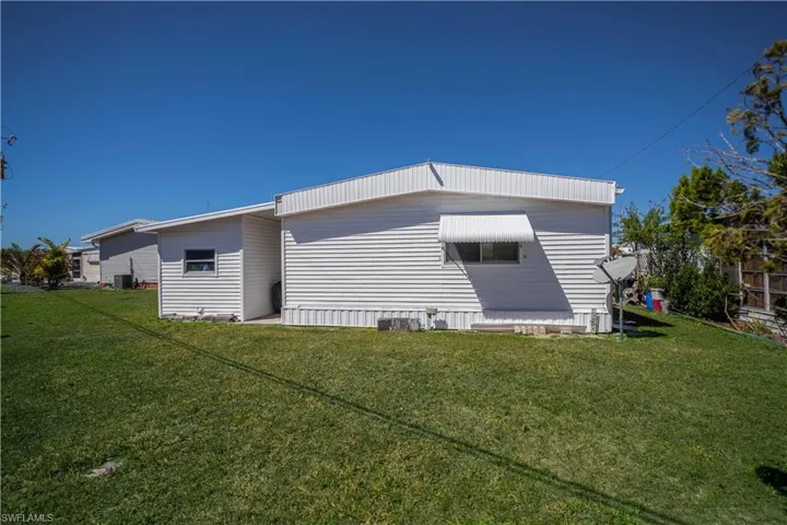 View of home's exterior with a yard