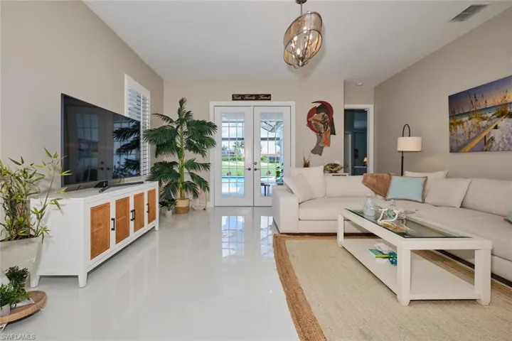 Living room with french doors and a chandelier