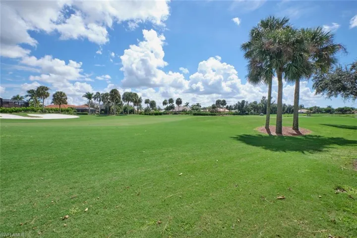 View of home's community with a yard