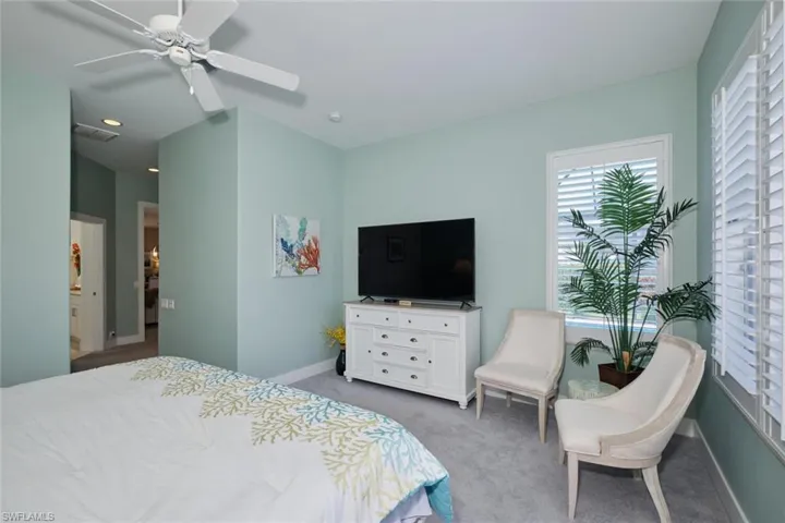 Carpeted bedroom with ceiling fan
