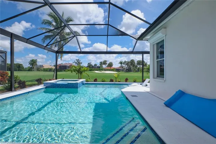 View of pool featuring an in ground hot tub and a lanai