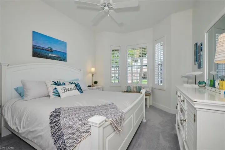 Carpeted bedroom with ceiling fan