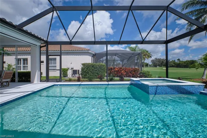View of pool featuring a patio area, a lanai, and an in ground hot tub