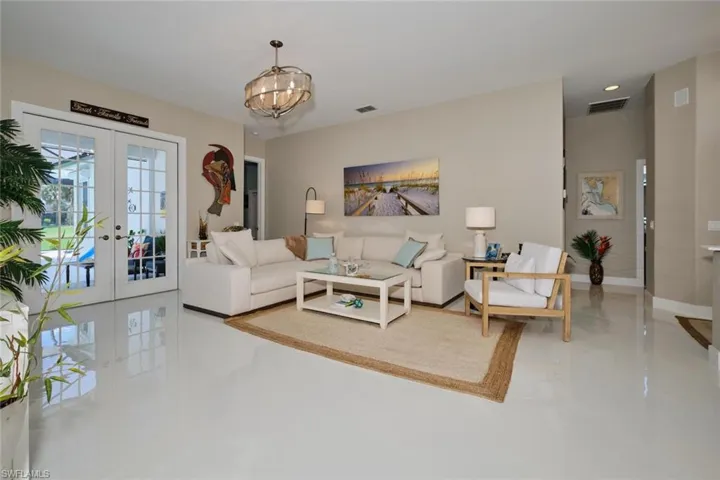 Living room featuring french doors and an inviting chandelier