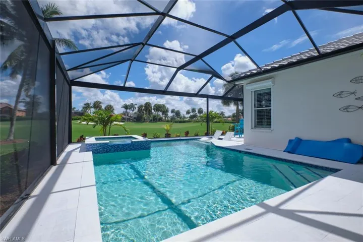 View of pool featuring a lanai, an in ground hot tub, and a patio