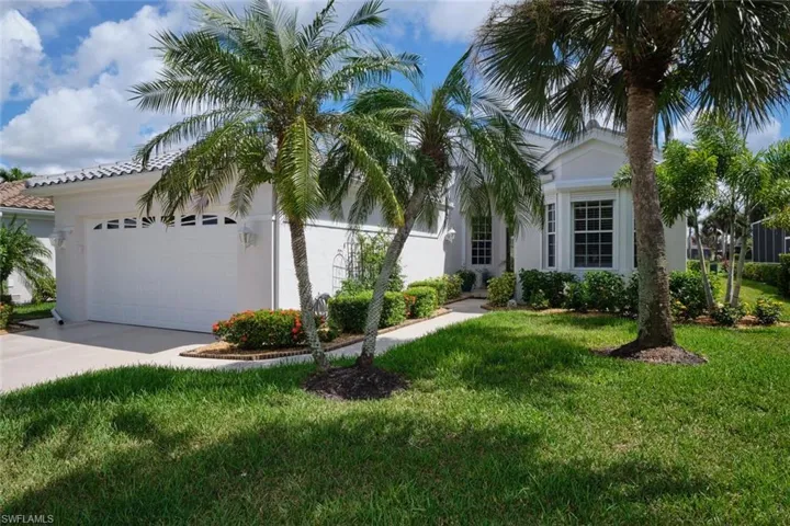 View of front of home featuring a front yard and a garage
