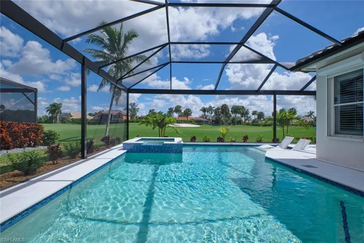 View of swimming pool featuring an in ground hot tub, a patio area, and a lanai