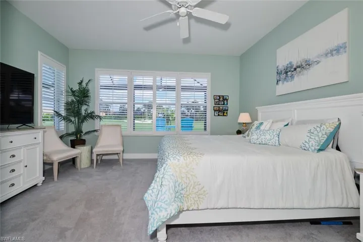 Bedroom with light carpet and ceiling fan