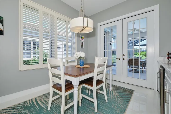 Tiled dining area featuring a wealth of natural light and french doors