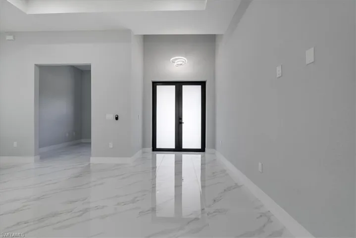 Empty room featuring french doors