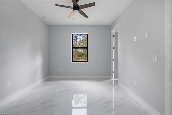 Spare room with ceiling fan