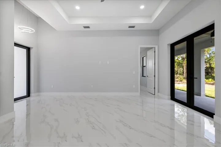 Spare room with a tray ceiling and french doors