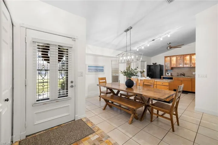 View of front door entryway and dining area