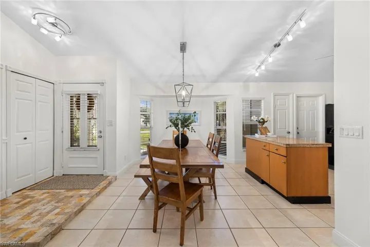 View of front door entryway, dining area, and kitchen