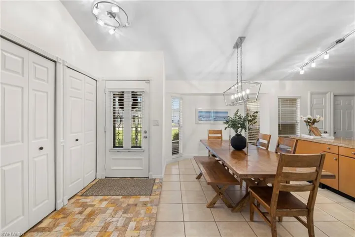 View of front door entryway and dining area