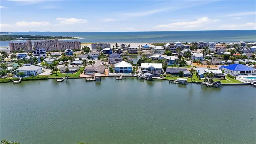 Coastal setting with waterfront properties, private docks, and distant beachfront