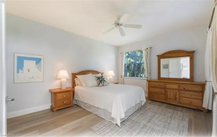 Bedroom featuring wood finished floors and a ceiling fan