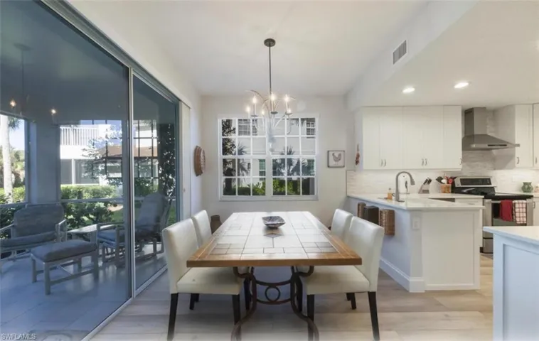 Dining space featuring a chandelier, recessed lighting, and light wood-style floors