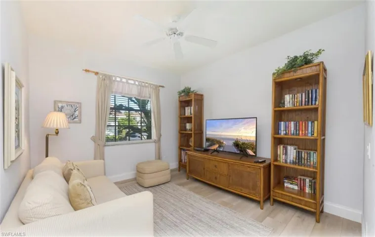 Living area with a ceiling fan and wood finished floors