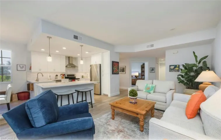 Living room with light wood-type flooring and recessed lighting