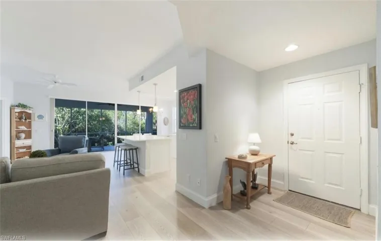 Entryway featuring light wood finished floors, ceiling fan, recessed lighting, and a chandelier