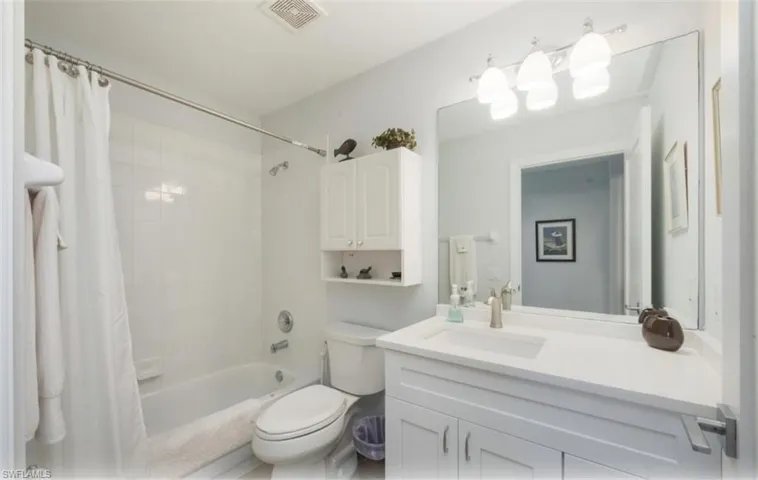 Bathroom with shower / bath combo and vanity