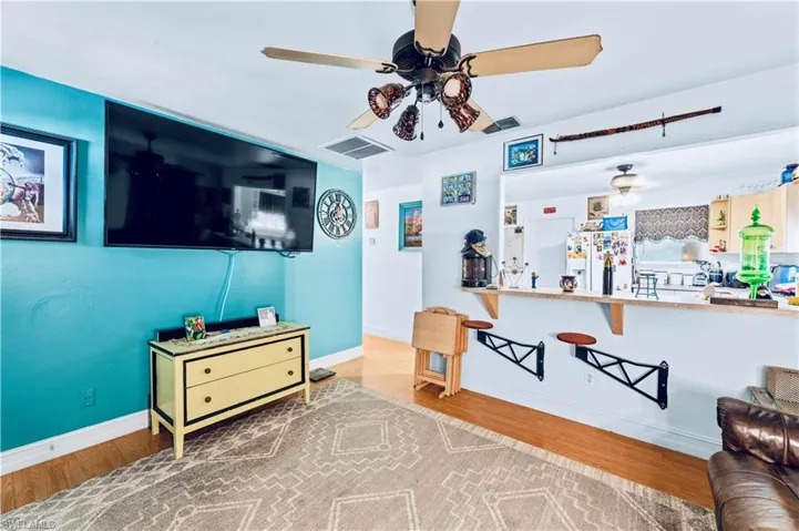 Living room featuring ceiling fan and hardwood / wood-style flooring