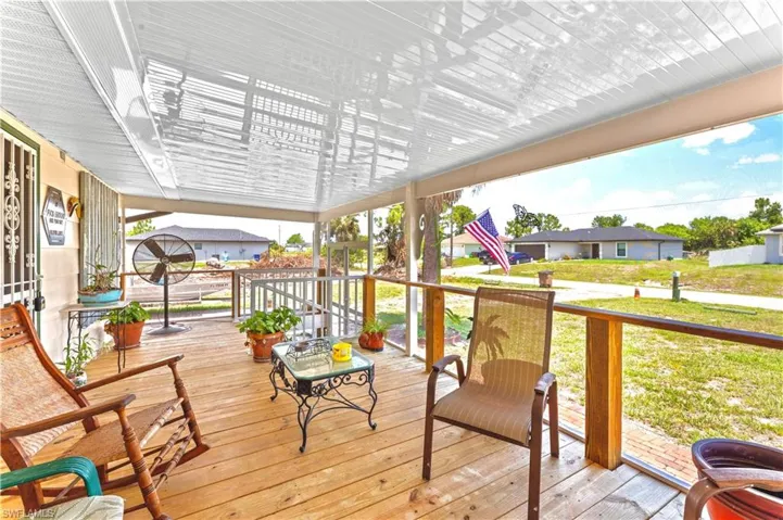 Wooden terrace featuring a yard