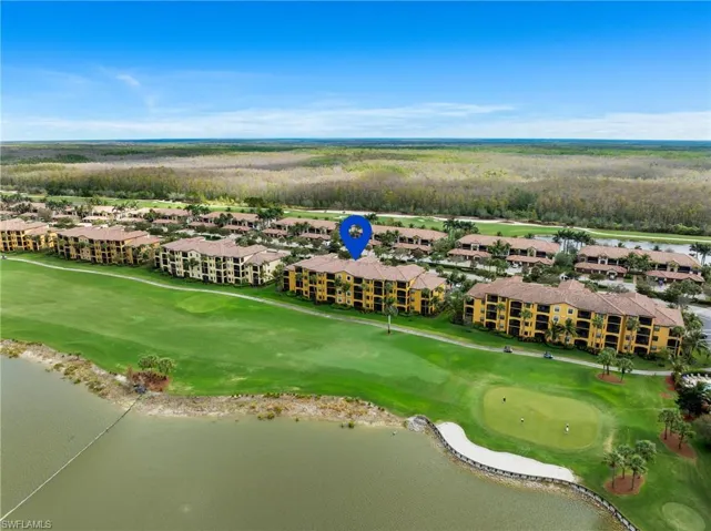 Bird's eye view with golf course view and a water view