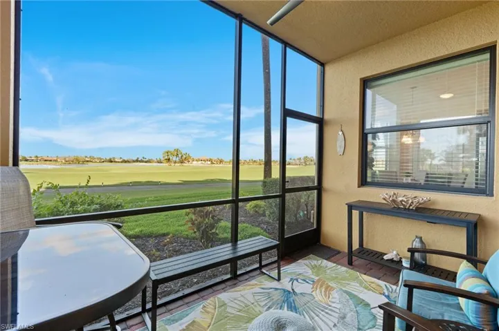 Sunroom featuring view of golf course