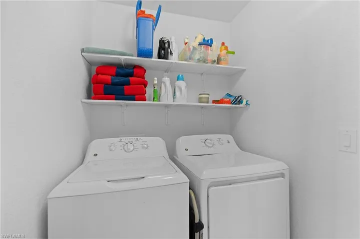 Laundry area with laundry area and washing machine and clothes dryer