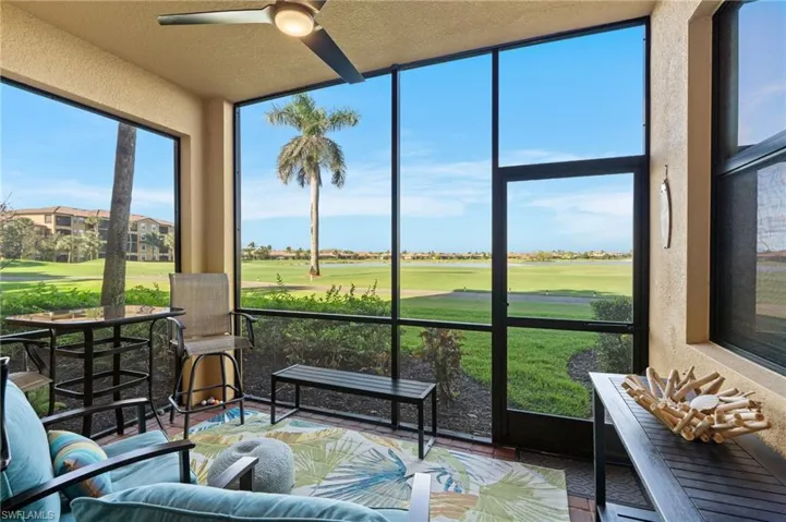 Sunroom / solarium featuring a ceiling fan and view of golf course
