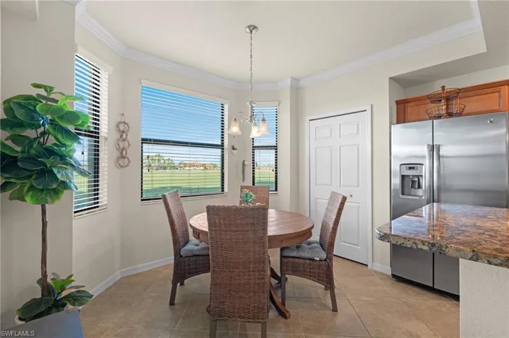 Dining room featuring an inviting chandelier, baseboards, and ornamental molding