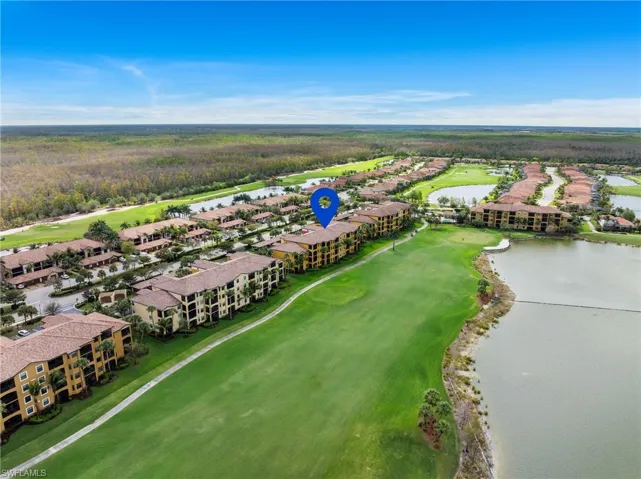 Birds eye view of property featuring a water view and golf course view