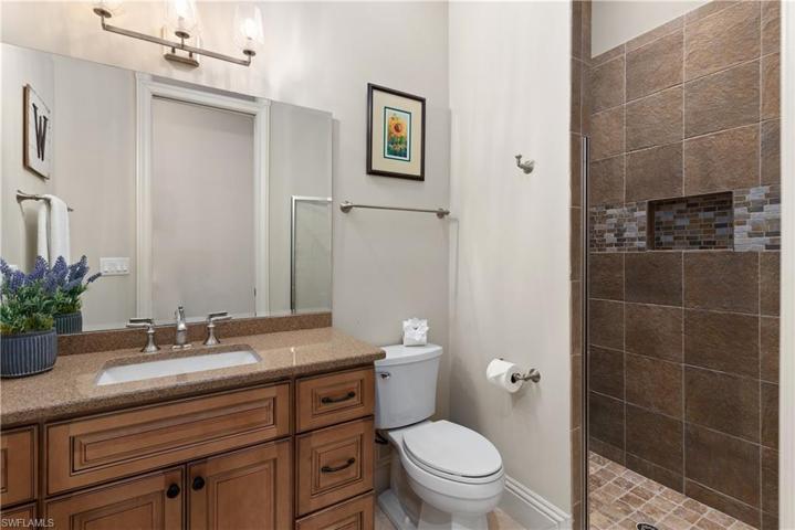 Full guest bath wtih decorative tile and granite counter